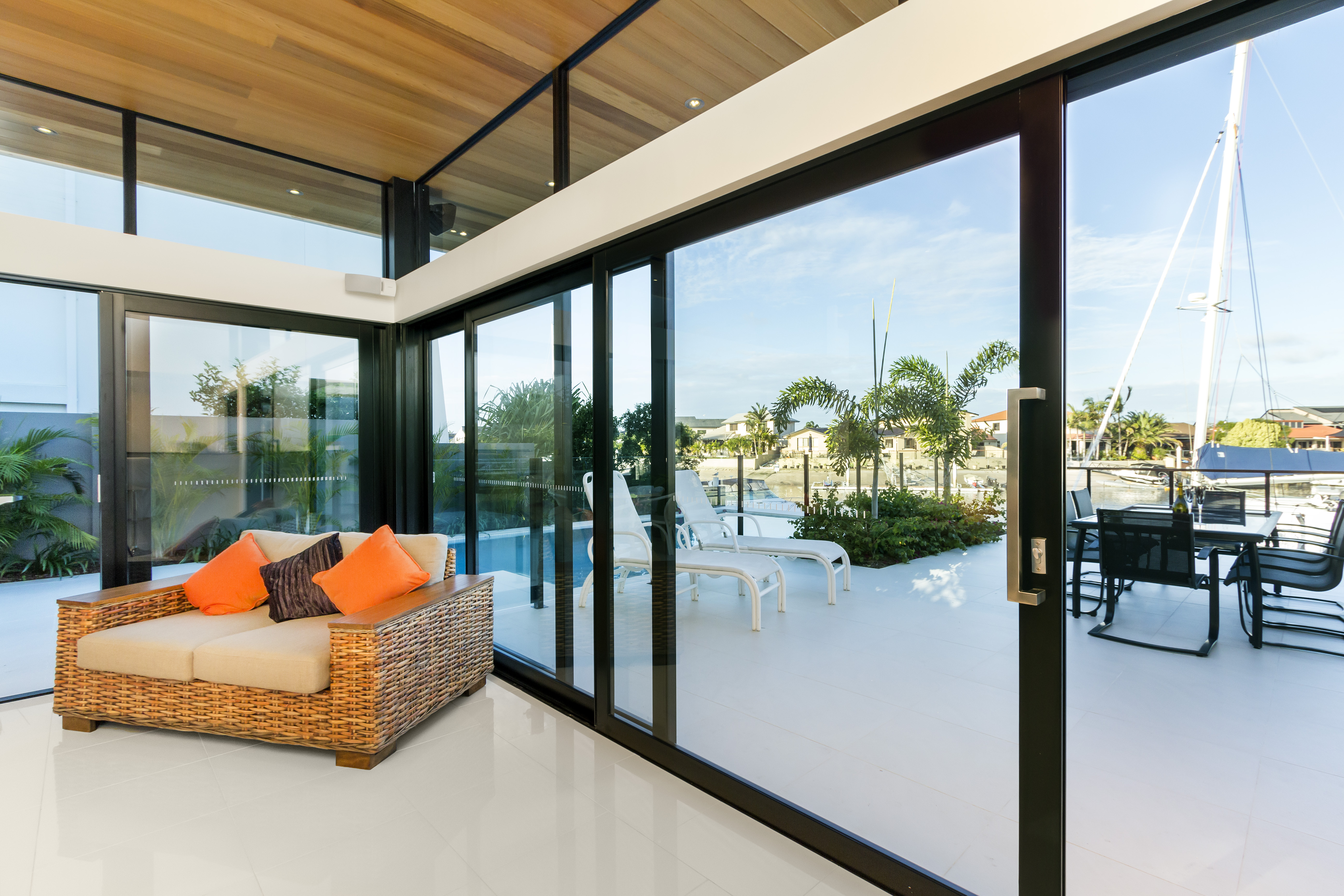 A lounge room setting, showing a couch and aluminium sliding doors